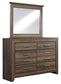 Juararo King Panel Bed with Mirrored Dresser and Chest at Lee Furniture, NC